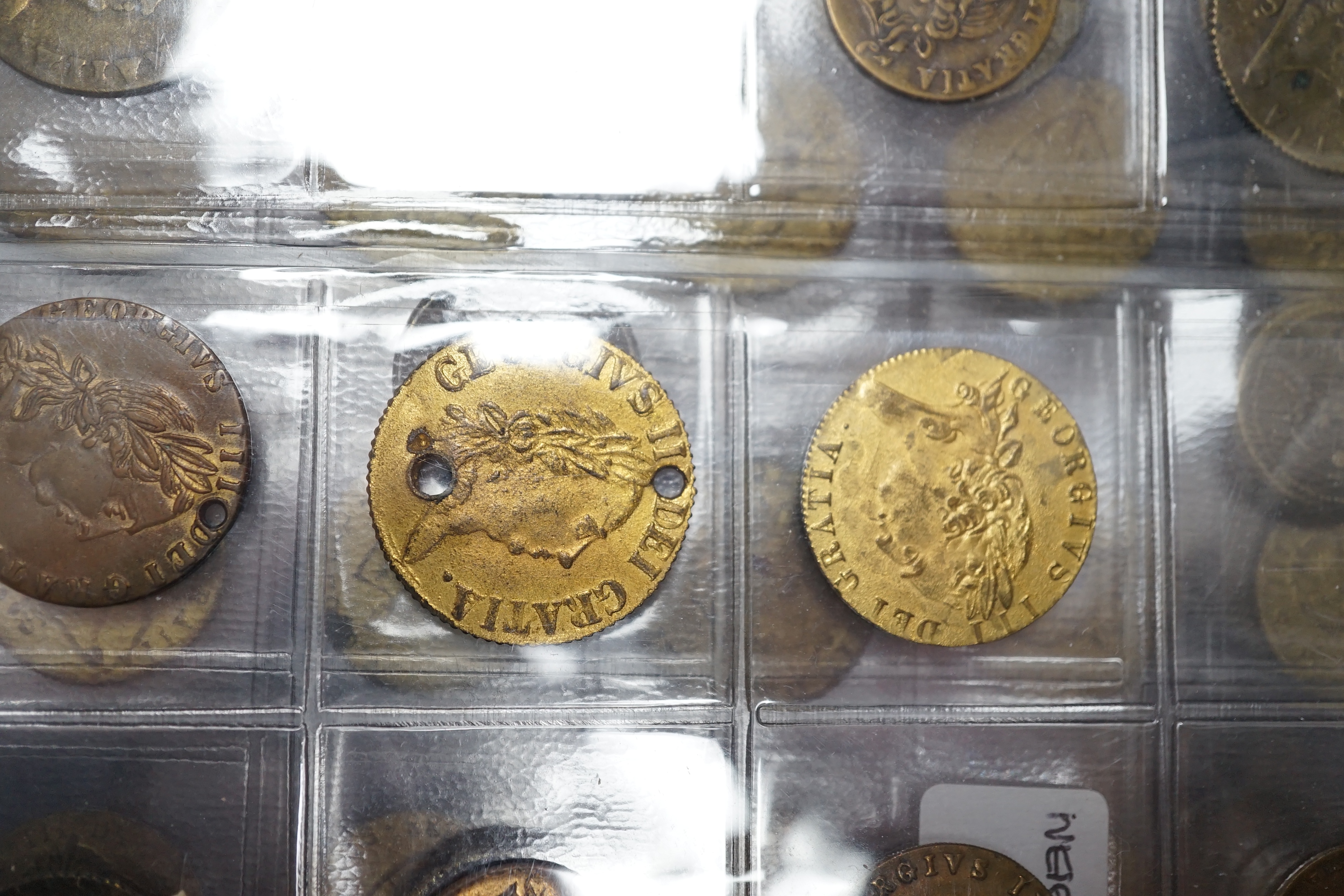 A large collection of halfpenny tokens and gaming tokens, 17th to early 20th century, in an album